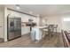 Modern kitchen with white cabinets, stainless steel appliances, and an island at 4084 Bruing St, North Port, FL 34286