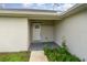 White front door entry with a walkway and landscaping at 4084 Bruing St, North Port, FL 34286