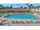 Community swimming pool with lounge chairs at 19029 Us Highway 19 N # 9-501, Clearwater, FL 33764