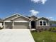 Charming single-story home with a two-car garage, stone accents, and well-maintained landscaping at 10736 Tippecanoe Pl, Parrish, FL 34219