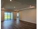 Spacious living room features wood floors, recessed lighting, access to lanai via sliding doors at 10736 Tippecanoe Pl, Parrish, FL 34219