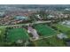 Expansive aerial view showcasing community sports fields near homes with lakes in a planned neighborhood at 11892 Frost Aster Dr, Riverview, FL 33579