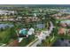 Aerial view of a community showcasing homes, a lake, swimming pool, and playground amenities at 11892 Frost Aster Dr, Riverview, FL 33579