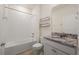 Bathroom featuring a shower-tub, toilet, granite-topped vanity, large mirror, and decorative shelving for storage at 11892 Frost Aster Dr, Riverview, FL 33579