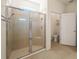 Modern bathroom featuring a glass-enclosed shower with tile surround and a separate toilet area for added privacy at 11892 Frost Aster Dr, Riverview, FL 33579