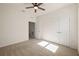 A simple, neutral bedroom featuring a ceiling fan and closet at 11892 Frost Aster Dr, Riverview, FL 33579