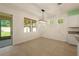 Bright dining area with a modern chandelier and views of the backyard and the screened porch at 11892 Frost Aster Dr, Riverview, FL 33579