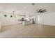 Open-concept living space with tile floors, modern lighting, and a stylish kitchen featuring an island at 11892 Frost Aster Dr, Riverview, FL 33579