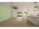 Spacious living area with tile flooring, ceiling fan, and sliding glass doors to the screened lanai at 11892 Frost Aster Dr, Riverview, FL 33579