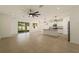 Open living area featuring tile floors, recessed lighting, and access to the kitchen and screened patio at 11892 Frost Aster Dr, Riverview, FL 33579