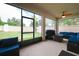 Relax on the screened patio, with a grill and comfortable seating, while enjoying views of the lush backyard at 11892 Frost Aster Dr, Riverview, FL 33579
