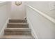 Carpeted staircase with white railing leading to the upper level at 3062 Victoria Inlet Dr, Holiday, FL 34691