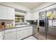 Kitchen with white cabinets, stainless steel appliances, and granite countertops at 30929 Eloian Dr, Wesley Chapel, FL 33545