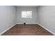 Spacious bedroom with wood-look flooring and large window at 18141 Sandy Pointe Dr, Tampa, FL 33647