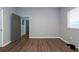 Bright bedroom featuring wood-look floors and access to other rooms at 18141 Sandy Pointe Dr, Tampa, FL 33647