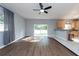 Open concept living room with kitchen access and view to backyard at 18141 Sandy Pointe Dr, Tampa, FL 33647