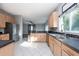 Modern kitchen with light wood cabinets, stainless steel appliances, and dark countertops at 18141 Sandy Pointe Dr, Tampa, FL 33647