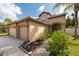 Two story home with three car garage and manicured landscaping at 18141 Sandy Pointe Dr, Tampa, FL 33647