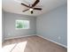 Bedroom with window, ceiling fan, and neutral decor at 18141 Sandy Pointe Dr, Tampa, FL 33647