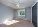 Bright bedroom with window, ceiling fan, and closet at 18141 Sandy Pointe Dr, Tampa, FL 33647