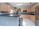 Modern kitchen with light wood cabinets, stainless steel appliances, and dark countertops at 18141 Sandy Pointe Dr, Tampa, FL 33647