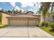 Two-story house with a three-car garage and well-maintained landscaping at 18141 Sandy Pointe Dr, Tampa, FL 33647