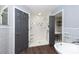 Modern bathroom with walk-in shower, soaking tub, and built-in shelving at 18141 Sandy Pointe Dr, Tampa, FL 33647