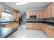 Modern kitchen with light wood cabinets, stainless steel appliances, and dark countertops at 18141 Sandy Pointe Dr, Tampa, FL 33647