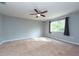Large bedroom with ceiling fan, window, and neutral wall color at 18141 Sandy Pointe Dr, Tampa, FL 33647