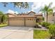 Two-story house with three-car garage and landscaped yard at 18141 Sandy Pointe Dr, Tampa, FL 33647