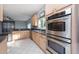 Modern kitchen with light wood cabinets, stainless steel appliances, and dark countertops at 18141 Sandy Pointe Dr, Tampa, FL 33647