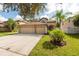 Two-story house with a three-car garage and landscaped yard at 18141 Sandy Pointe Dr, Tampa, FL 33647