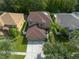 Two-story house with brown roof, surrounded by lush greenery at 18141 Sandy Pointe Dr, Tampa, FL 33647
