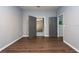 Well-lit bedroom with dark gray doors and wood-look floors at 18141 Sandy Pointe Dr, Tampa, FL 33647