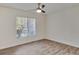 Bedroom with large window and wood-look tile floors at 107 Seville N Ct, Plant City, FL 33566