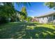 Backyard with large trees, grassy area, and a patio at 710 W Braddock St, Tampa, FL 33603
