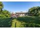 Large backyard with grassy area and a home with deck at 710 W Braddock St, Tampa, FL 33603