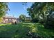 Spacious backyard with large grassy area, mature trees, and patio at 710 W Braddock St, Tampa, FL 33603