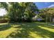 Large backyard with lush landscaping and a wooden fence at 710 W Braddock St, Tampa, FL 33603