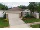 One-story home with attached garage and landscaping at 11892 Frost Aster Dr, Riverview, FL 33579