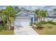 Light blue single-Gathering home with white garage door and landscaping at 4325 Renwick Dr, Parrish, FL 34219