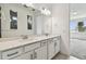 Bright bathroom featuring double sinks, quartz countertops, and sleek modern fixtures and a view to the bedroom beyond at 13715 Brookside Haven St, Riverview, FL 33578