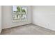 Bright bedroom with carpet floors and large window offering plenty of natural light at 13715 Brookside Haven St, Riverview, FL 33578