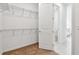 Spacious walk-in closet with shelving system and a view to the bathroom beyond at 13715 Brookside Haven St, Riverview, FL 33578