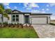 Charming single-story home featuring a well-manicured lawn and paved driveway at 13715 Brookside Haven St, Riverview, FL 33578