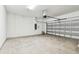 Spacious two-car garage with concrete floor and an automatic door opener at 13715 Brookside Haven St, Riverview, FL 33578