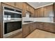 Contemporary kitchen features stainless steel appliances, light countertops, and wooden cabinets at 13715 Brookside Haven St, Riverview, FL 33578