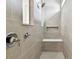 Walk-in shower featuring contemporary tile, a built-in bench, a niche, and a modern showerhead at 13715 Brookside Haven St, Riverview, FL 33578