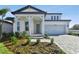 Charming two-story home featuring a stylish entrance, a two-car garage, and beautiful landscaping at 13810 Sunlight Meadow Dr, Riverview, FL 33578