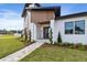 Modern home entrance with walkway, landscaping, and a covered entry at 2855 Sunstream Ln, Clearwater, FL 33759